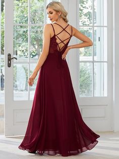 a woman in a long burgundy dress looking back