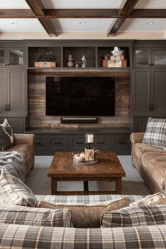 a living room filled with furniture and a flat screen tv mounted on a wall above a wooden coffee table