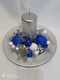 a silver candle holder with blue and white ornaments