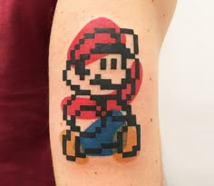 a person with a mario bros tattoo on their arm