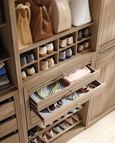 an organized closet with shoes, purses and handbags in it's drawers