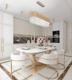 a dining room table with white chairs and a chandelier hanging from the ceiling