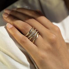 a woman's hand with three rings on it