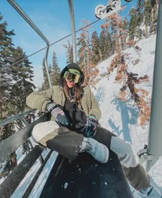 a woman sitting on the side of a ski lift