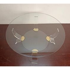 a glass plate with two metal handles on a wooden table