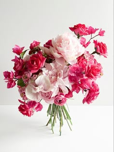 a bouquet of pink and white flowers on a table