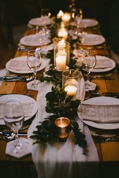 a long table is set with candles and place settings for an elegant dinner or party