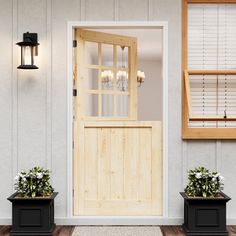 two planters with flowers are sitting in front of the entrance to a house that is painted white