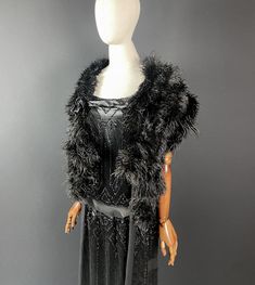 Glamorous 1920s Art Deco ostrich feather shawl or shrug from Paris.  Whisper light, the feathers floats gracefully around your body accentuating every movement. Artfully made with rows of glossy ostrich feathers that end in long loops or tassels to form a dramatic silhouette. All original and in fabulous condition with minimal shedding.  The black silk lining features darts and is curved to sit elegantly on the shoulder. Fastens with a silk ribbon across the bust that hooks in place. I purchased this from an estate sale in Paris, and can attest that it has been lovingly kept in a large hat box for nearly 100 years. It is such a rare, and beautiful find. Pictured here over a Lanvin haute couture dress ( dress will be listed soon ). Measures: 155 cm length includes x 23 cm width In fantastic Girls Apron Dress, Bustle Skirt, 1920s Flapper, Large Hats, Haute Couture Dresses, 1920s Art Deco, Apron Dress, Ostrich Feathers, Vintage Bridal