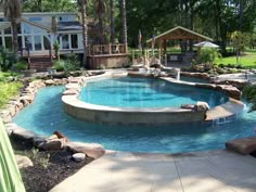 a backyard with a swimming pool surrounded by trees