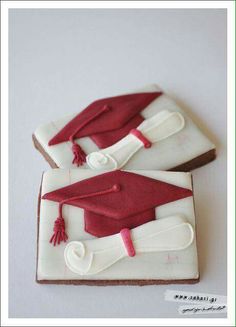 two decorated cookies with graduation caps and tassels