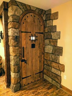 a large wooden door sitting inside of a stone wall