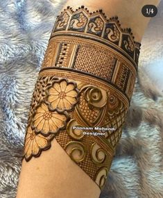 a woman's arm with hennap on it and flowers in the middle