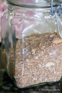 a glass jar filled with lots of sand