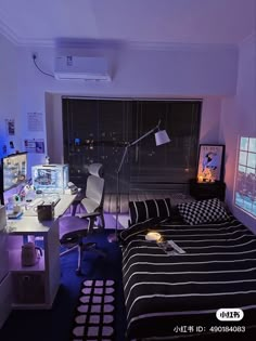 a bed room with a neatly made bed and two monitors