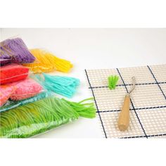 a pair of scissors sitting on top of a table next to some tassels