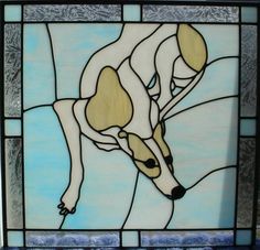 a stained glass window with a dog on it's back and head in the center