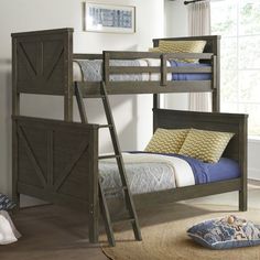 a wooden bunk bed with two sets of ladders on the bottom and one set of pillows