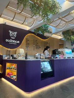 a food court with purple walls and lights