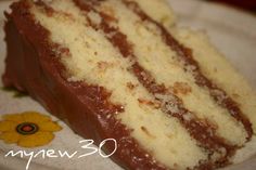 a piece of cake sitting on top of a white plate with yellow and brown flowers