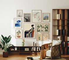 a living room with pictures on the wall and a chair next to a book shelf