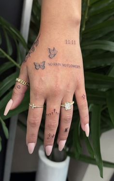 a woman's hand with tattoos on it