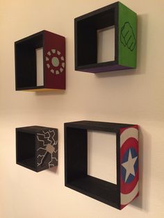 three wooden blocks are mounted to the wall, each with different designs and shapes on them