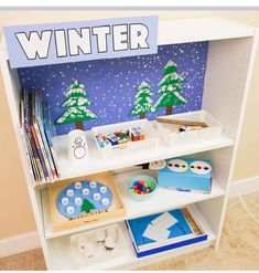 a white book shelf filled with lots of books and crafting supplies on top of a carpeted floor