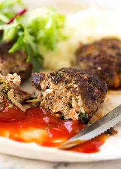 meatballs with ketchup and vegetables on a plate