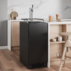 a black refrigerator sitting in the middle of a kitchen next to a counter with stools