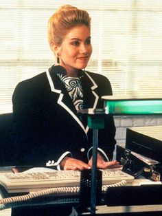 a woman sitting at a desk in front of a computer