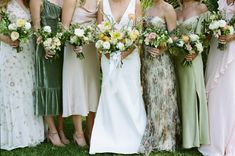 a group of women standing next to each other wearing dresses and holding bouquets in their hands