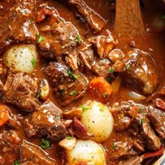 a close up of food in a bowl with meat and veggies on it