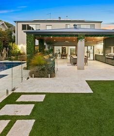 an outdoor living area with grass and landscaping