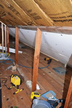 an attic with wood floors and tools on the floor