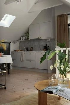 an open kitchen and dining room with skylights