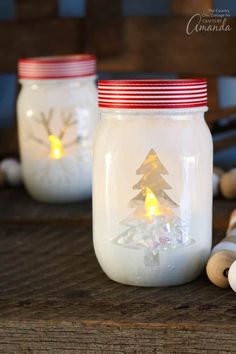 two mason jars with christmas trees in them