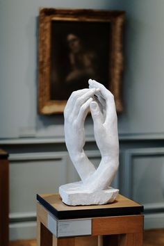 a white sculpture sitting on top of a wooden table