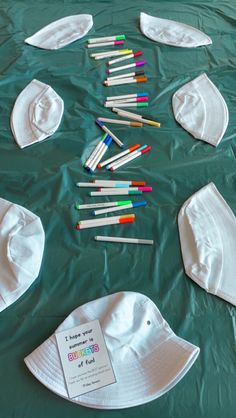 there are many crayons laid out on the table to be made into hats