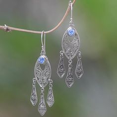 Graceful and beautiful these chandelier earrings evoke Balinese wind chimes. Komang Suastra works in sterling silver adding faceted blue topaz gems that total one carat. Silver Chandelier Earrings, Silver Chandelier, Balinese, Natural Turquoise, Jewelry Packaging, Hook Earrings, Chandelier Earrings, Jewelry Gift Box, Free Jewelry