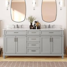 two mirrors are above the double sink vanity in this white and gray bathroom with wood flooring