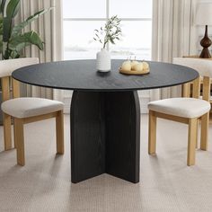 a black table with two chairs and a vase on it in front of a window