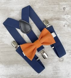 an orange bow tie and matching blue suspenders