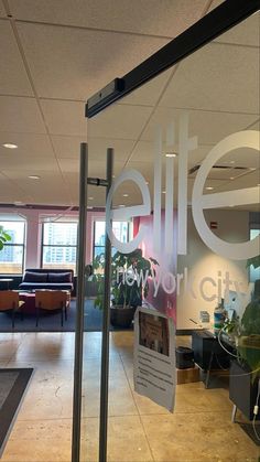 an office with glass walls and plants in the window, as well as a sign that reads'suite for city '