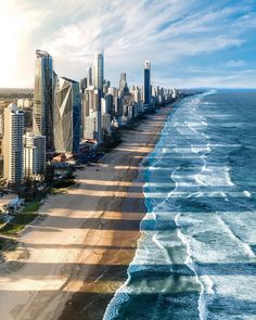 an aerial view of surfers on the beach in gold coast