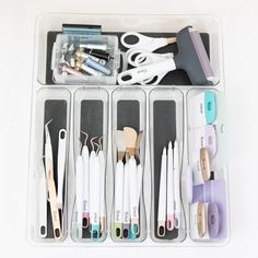 an assortment of crafting supplies in a plastic container