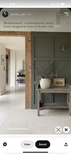 an image of a living room with grey walls and white flooring on the phone