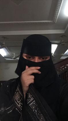 a person wearing a black head covering