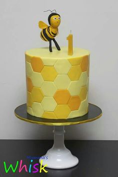 a yellow and white cake with a bee on top