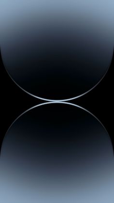 an abstract black and blue background with two circles in the middle, one circle is slightly blurry